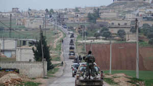 Members of al Qaeda's Nusra Front drive in a convoy as they tour villages in the southern countryside of Idlib