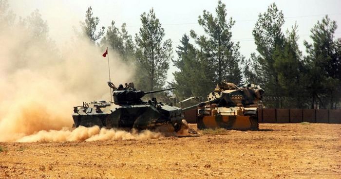 A Turkish army tank and an armoured vehicle are stationed near the Turkish-Syrian border in Karkamis in the southeastern Gaziantep province, Turkey, August 23, 2016. Picture taken August 23, 2016. Ihlas News Agency via REUTERS ATTENTION EDITORS - THIS PICTURE WAS PROVIDED BY A THIRD PARTY. FOR EDITORIAL USE ONLY. NO RESALES. NO ARCHIVE. TURKEY OUT. NO COMMERCIAL OR EDITORIAL SALES IN TURKEY. TPX IMAGES OF THE DAY