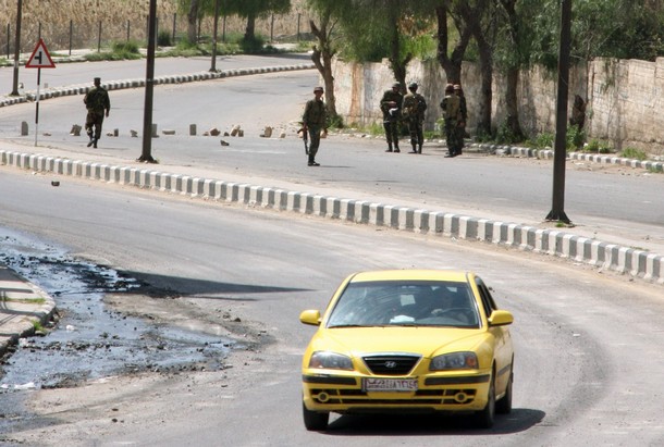 Syrian security forces man a checkpoint in the southern town of Daraa, 100 kms (60 miles) south of Damascus, on March 21, 2011. Daraa has become the unexpected nerve centre of anti-regime protests in Syria, with protesters holding daily demonstrations since Friday despite a huge deployment of security forces and a heavy-handed crackdown on protests that left five dead. AFP PHOTO/ STR (Photo credit should read -/AFP/Getty Images)